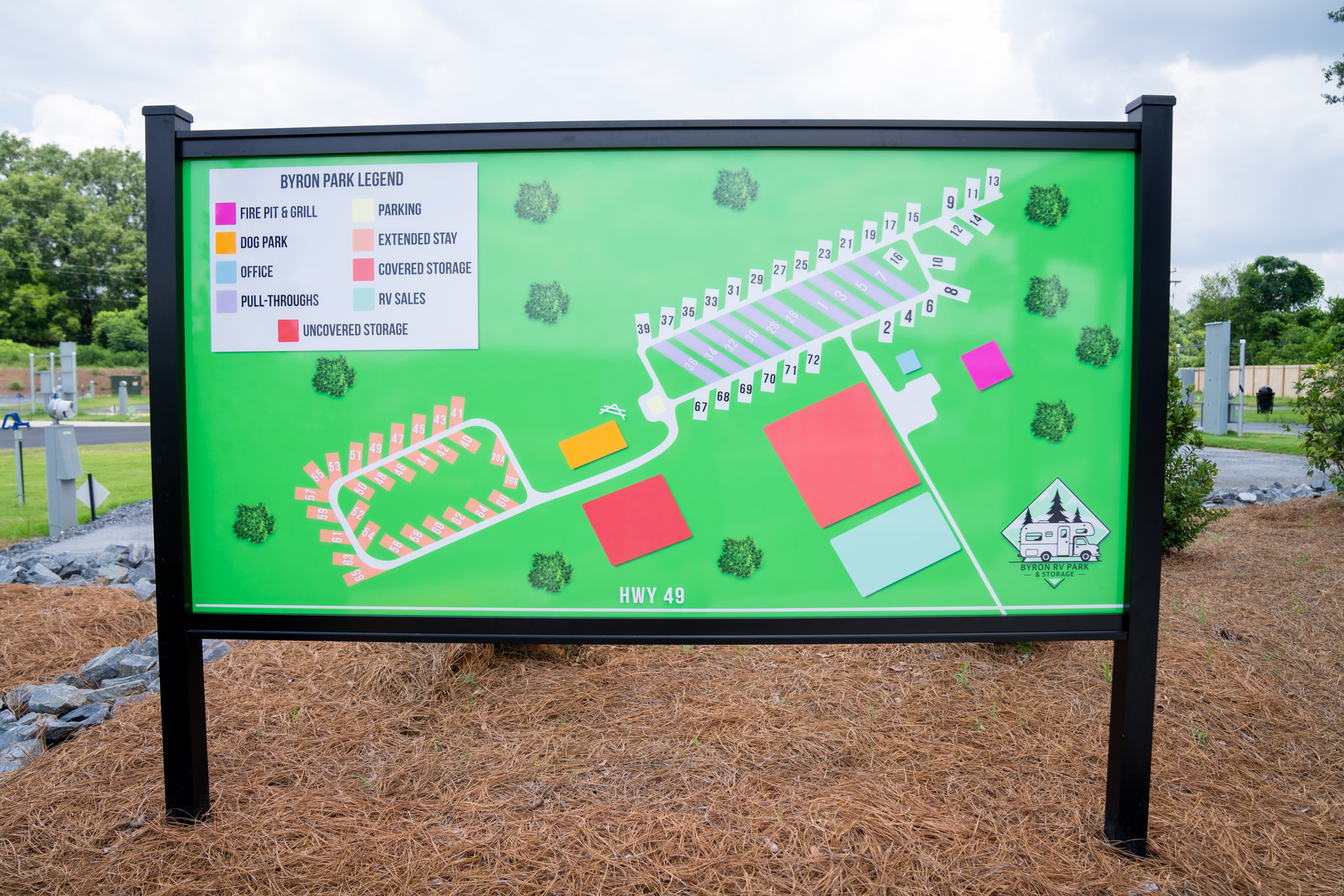 A large park map on a green background shows numbered lots, color-coded areas for office, storage, parking, fire pit, dog park, and pull-throughs, with a legend on the upper left.